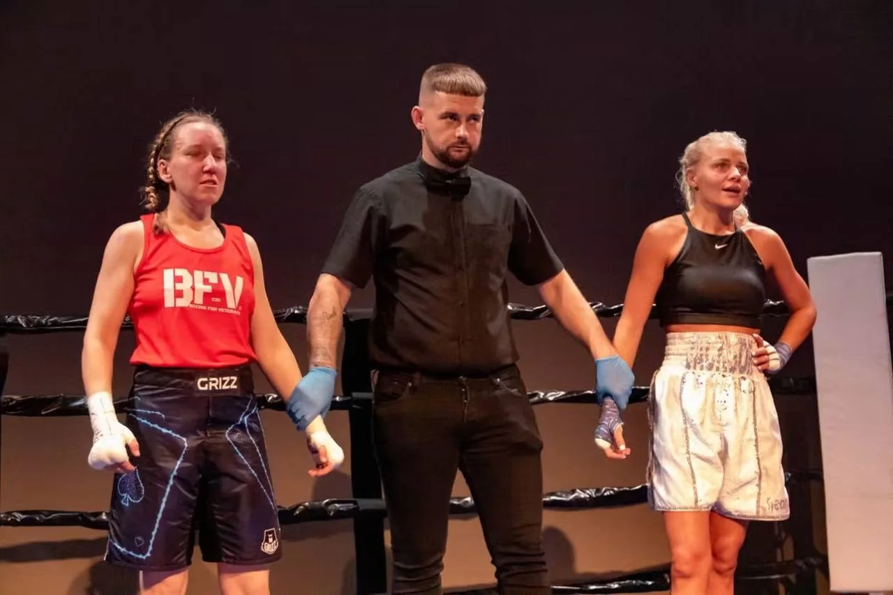 A referee holding two BFV boxers hands after their bout