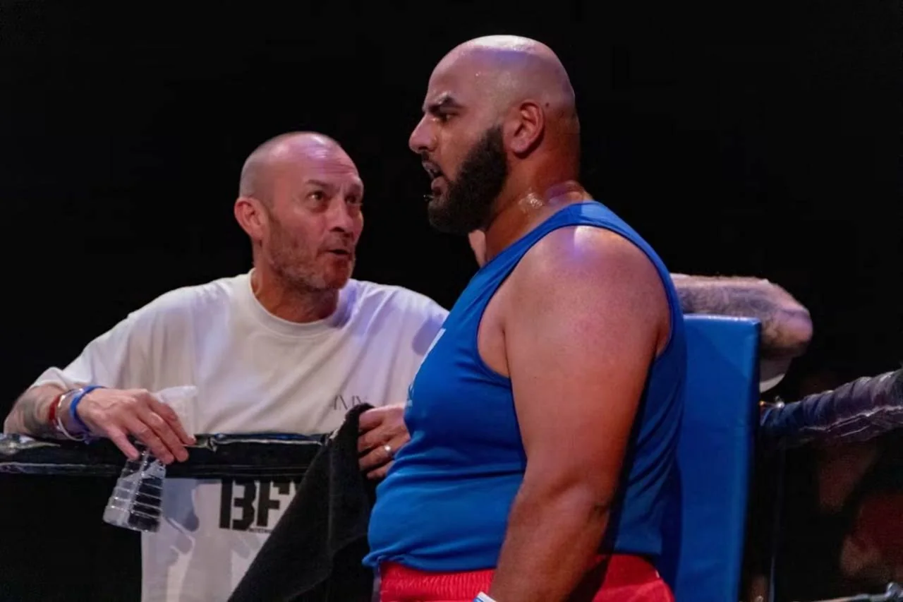 A coach speaking with a BFV boxer in the corner